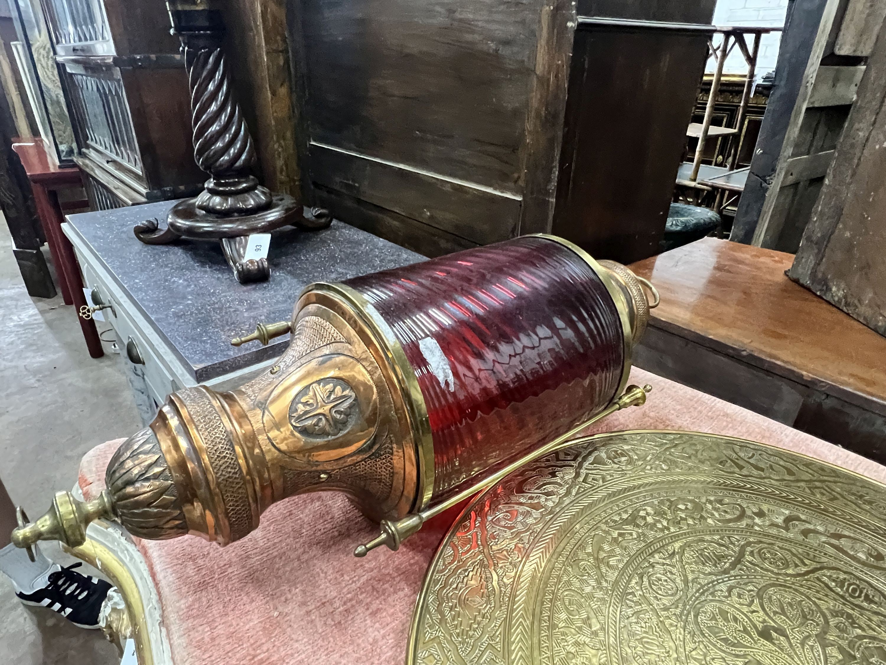 A copper and ruby glass lantern, height 70cm, a Moorish brass lantern, height 52cm and a Benares brass table top